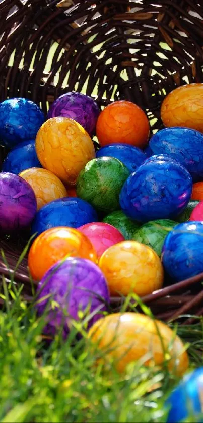 Colorful Easter eggs spilling from a wicker basket onto green grass.