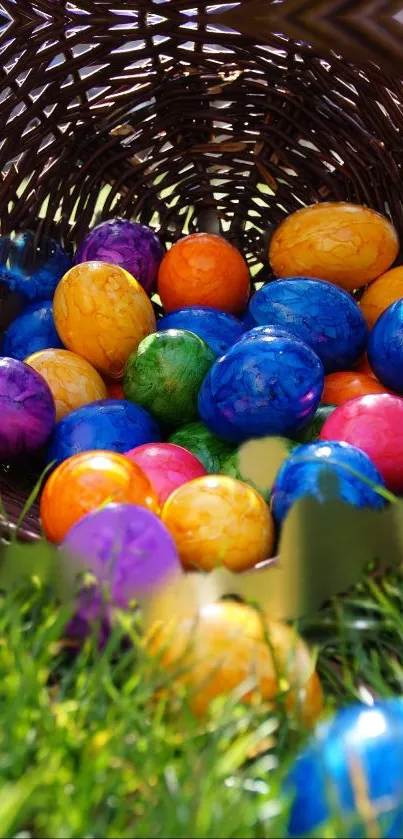 Colorful Easter eggs spill from a basket onto green grass.