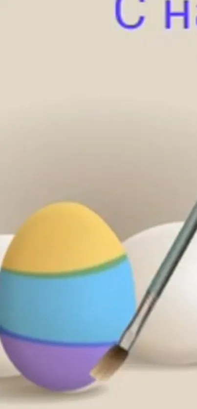 Colorful painted Easter egg with pastel stripes and a brush.