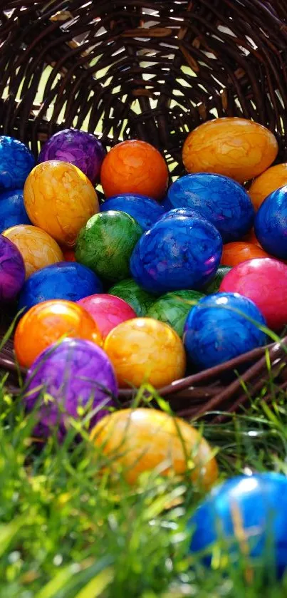 Colorful Easter eggs spilling from a basket on green grass.