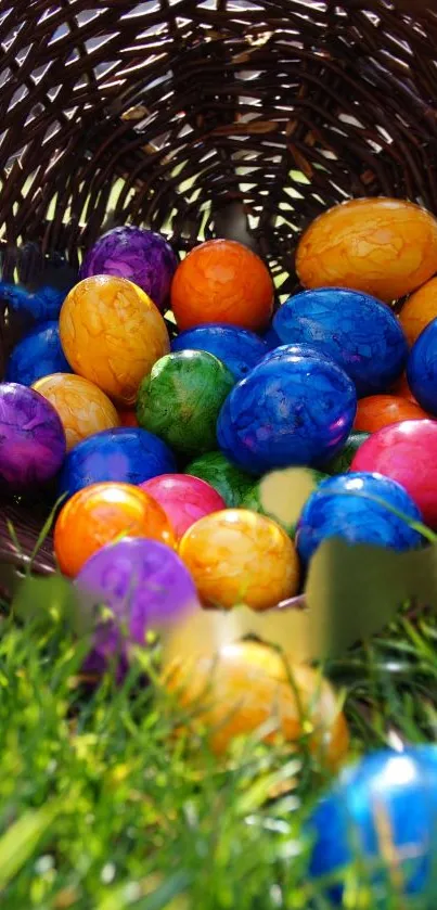 Colorful Easter eggs spilling from a basket on grass.