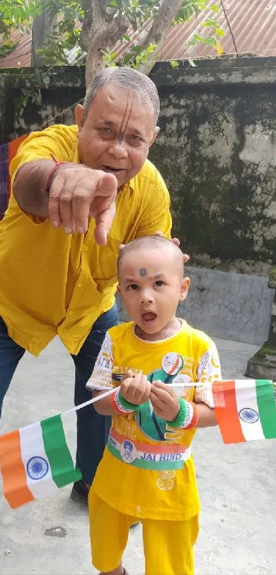 Family celebrating with flags and smiles in vibrant attire.