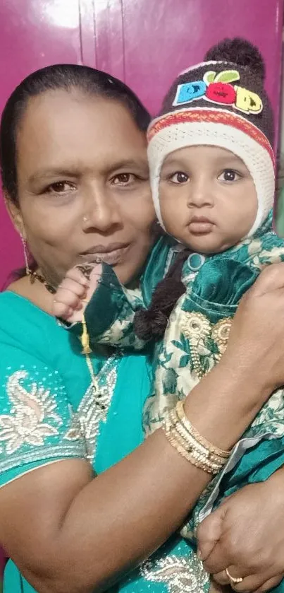 A mother lovingly holds her child, both dressed in colorful traditional attire.