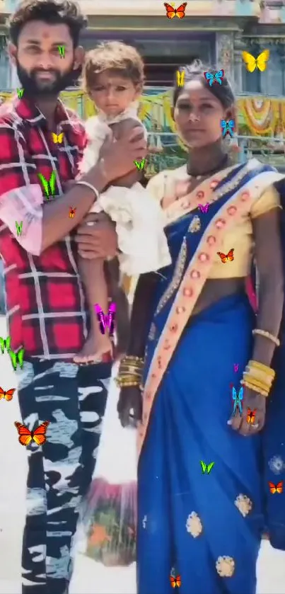 Vibrant family portrait with butterflies and blue sari in a cultural setting.