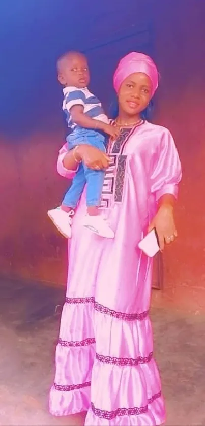 Mother holding child in colorful attire against a vibrant background.