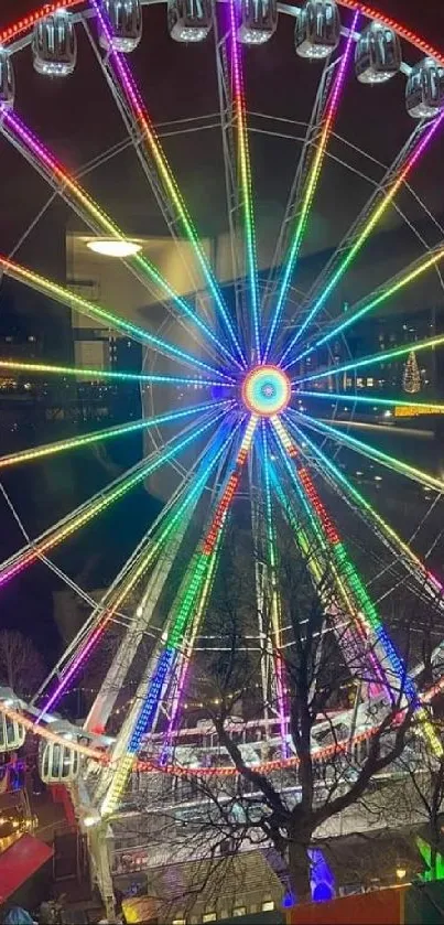 A colorful Ferris wheel illuminated at night with bright, vibrant LED lights.