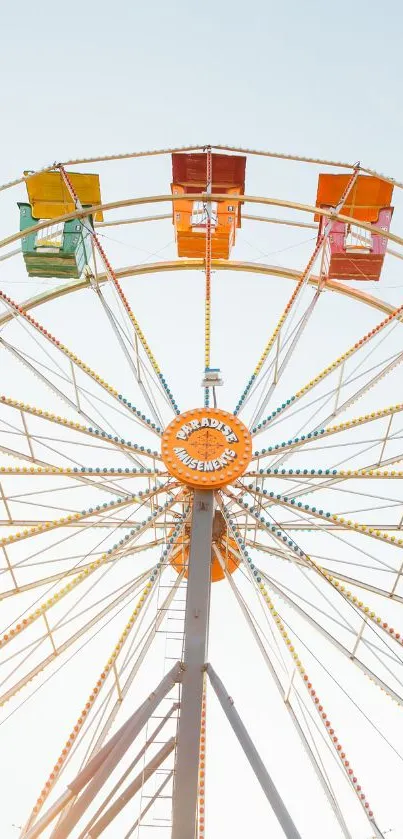 Colorful Ferris wheel against a clear blue sky.