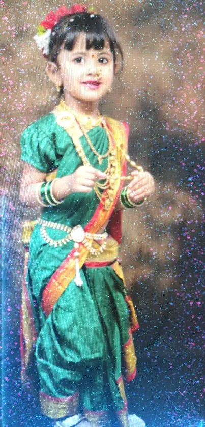 A young girl in green traditional attire posing cheerfully.