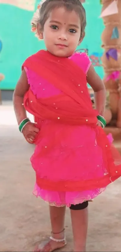 Child in vibrant traditional dress on a festive background.