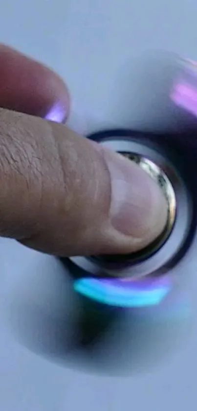 Close-up of a hand spinning a vibrant fidget spinner against a blurred background.