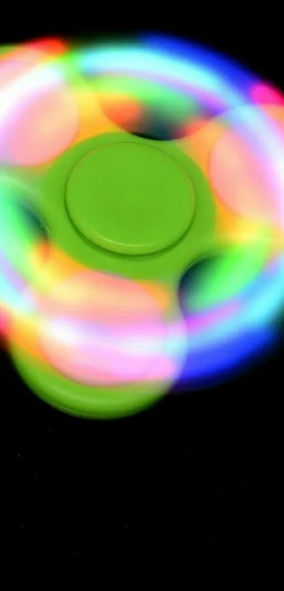 Vibrant LED fidget spinner on a dark background.