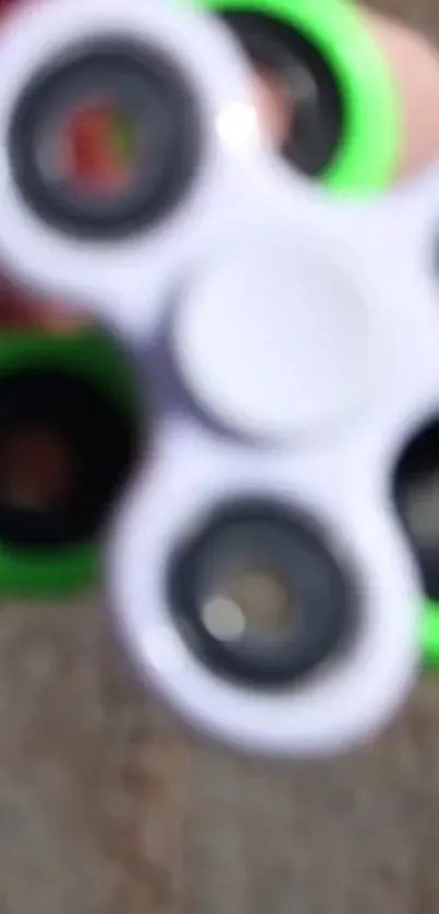 Blurry fidget spinner with a neon green detail.