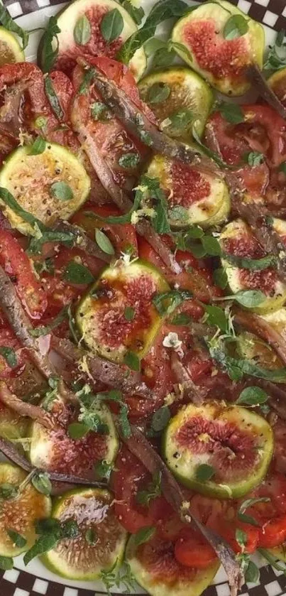 Colorful platter of figs and tomatoes with herbs.