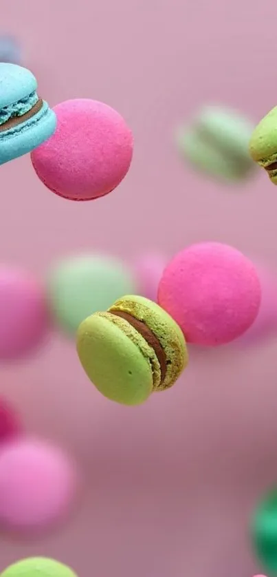 Colorful macarons floating on a pink background, perfect for mobile wallpaper.