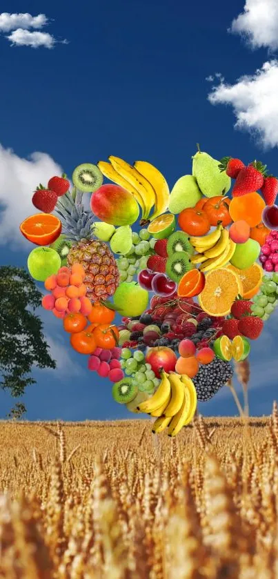 Colorful fruit heart collage on a scenic blue sky background.