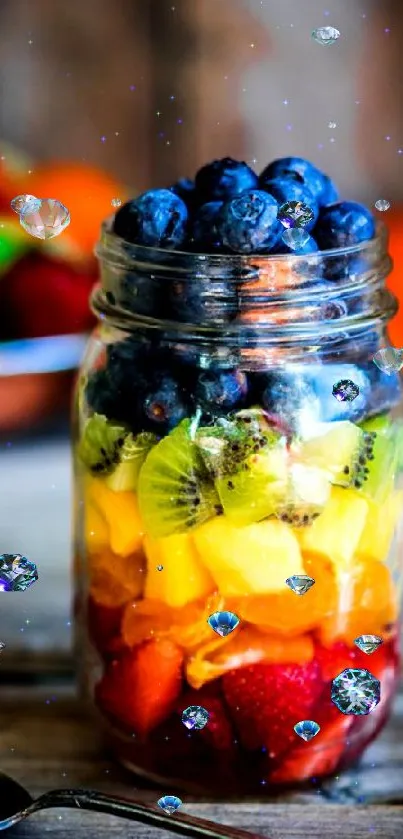 Colorful layered fruit jar with blueberries, kiwi, pineapple, and strawberries.