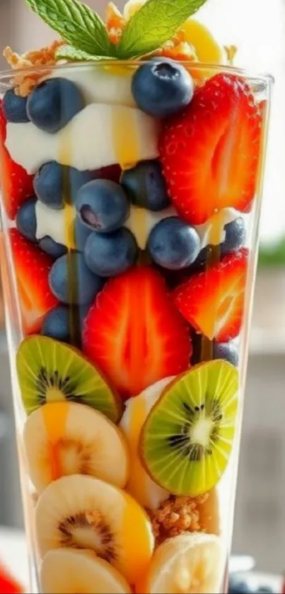 Colorful fruit parfait with berries and kiwi in a glass.