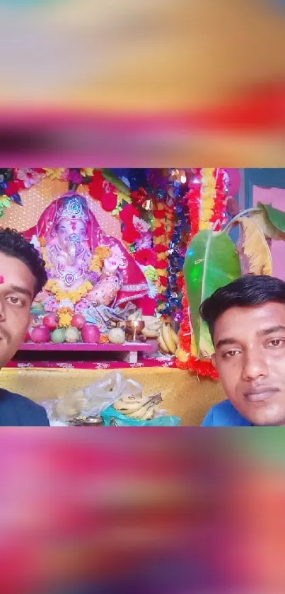 Colorful Ganesh festival decoration with two people in the foreground.