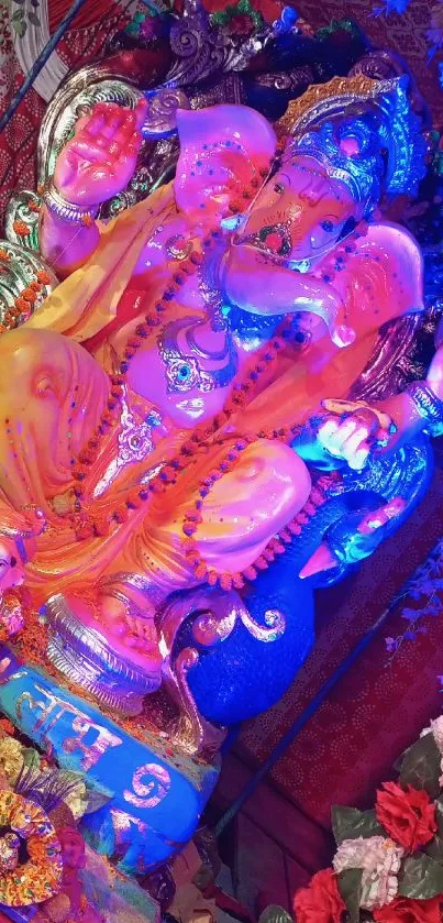 Vibrant Ganesh idol adorned with colorful decorations amidst festive background.