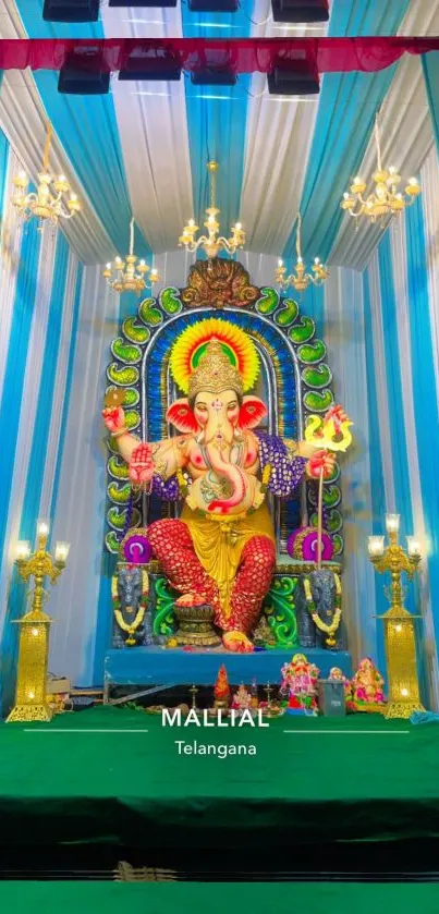 Colorful Ganesh idol with vibrant backdrop in temple setting.