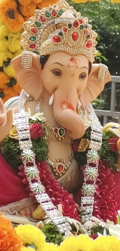 Colorful Ganesha statue surrounded by flowers.