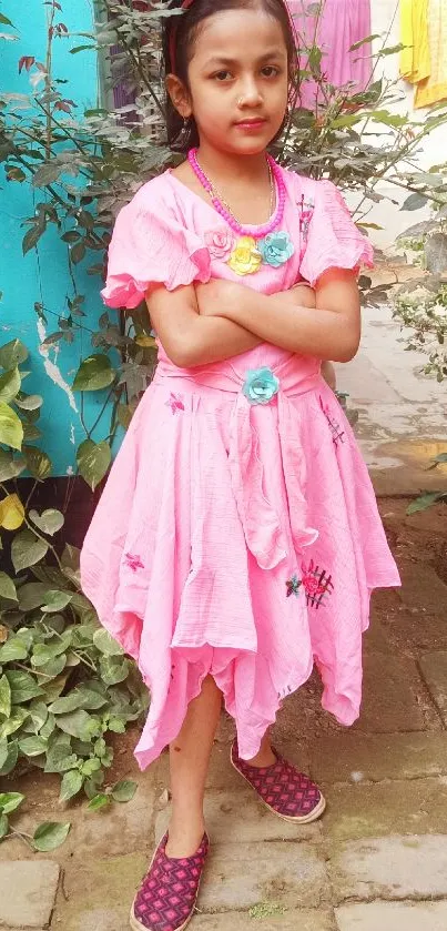 Girl in a pink dress in garden setting.