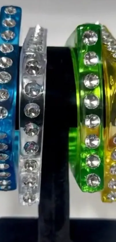Colorful gemstone bangles on a display stand.