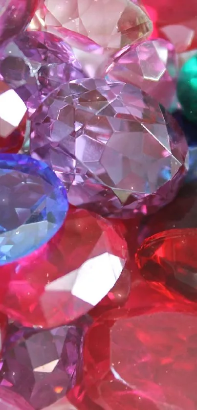 Colorful gemstone wallpaper with red, pink, green, and blue stones.