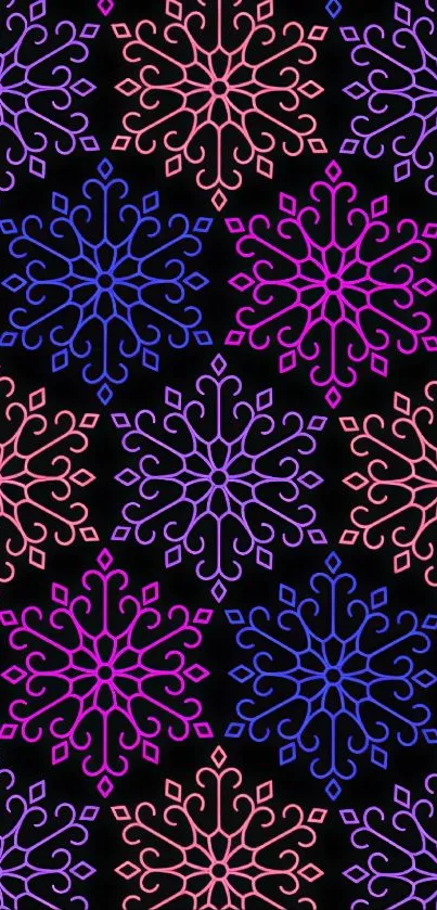 Vibrant snowflake pattern with pink, purple, blue on black background.