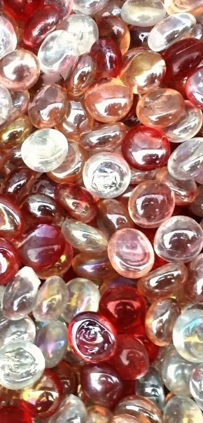 Colorful glass pebbles with red and orange hues create a vibrant wallpaper.