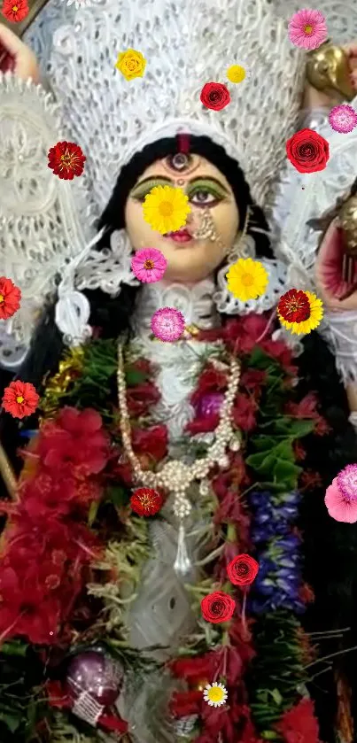 A goddess statue adorned with colorful flowers and intricate attire.