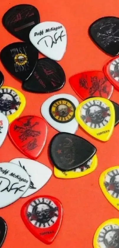 Assorted guitar picks on an orange background.