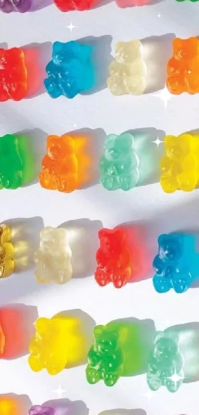 Colorful gummy bears arranged in rows on a wallpaper.