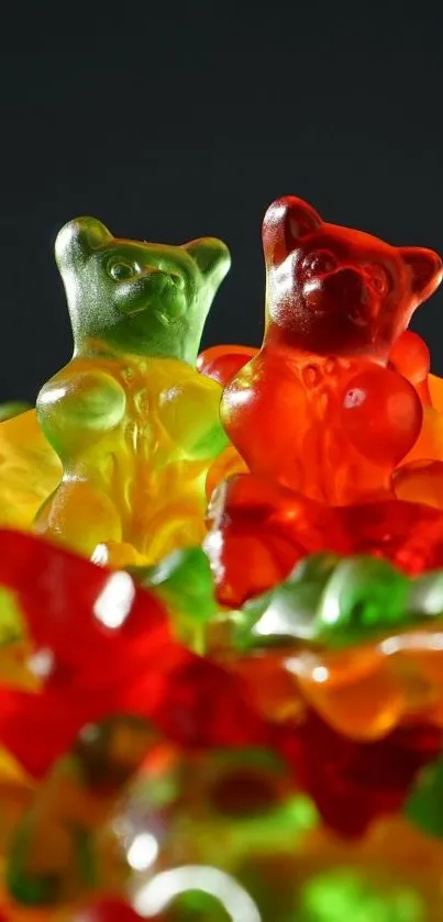 Colorful gummy bears in red and green shades on a dark background.