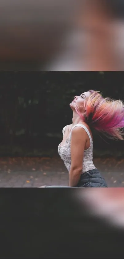 Woman with vibrant hair in motion against a dark blurred backdrop.