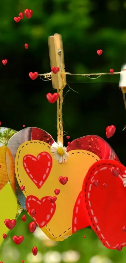 Colorful paper hearts hanging on a line with a green background.