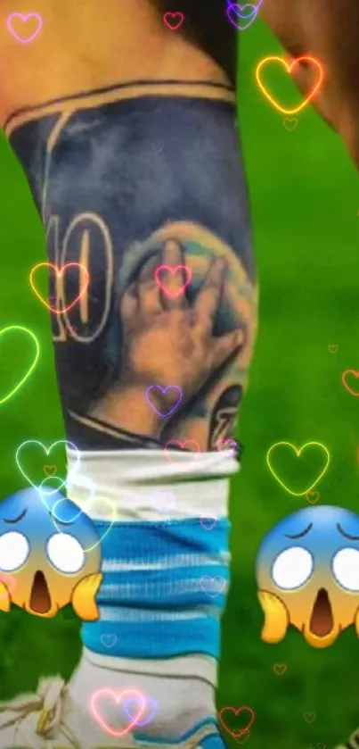 Colorful tattoo with hearts and emojis on a green background.