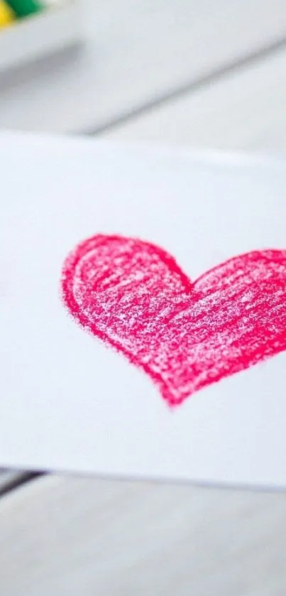 Red crayon heart on white paper background.