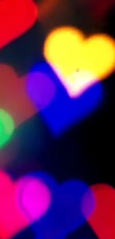 Colorful bokeh hearts with black background.