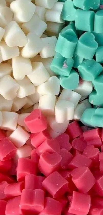 Pastel heart-shaped candies in turquoise, white, and pink hues.