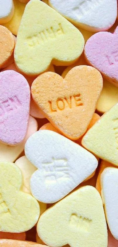 Heart-shaped candy in pastel colors including pink, yellow, and white.
