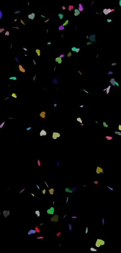 Colorful heart confetti scattered on a black background wallpaper.