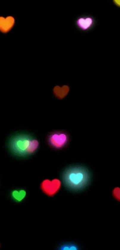 Colorful glowing hearts on a black wallpaper background.