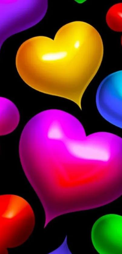 Colorful glossy hearts on black background wallpaper.