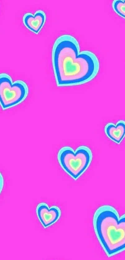 Pink background with colorful heart pattern wallpaper.