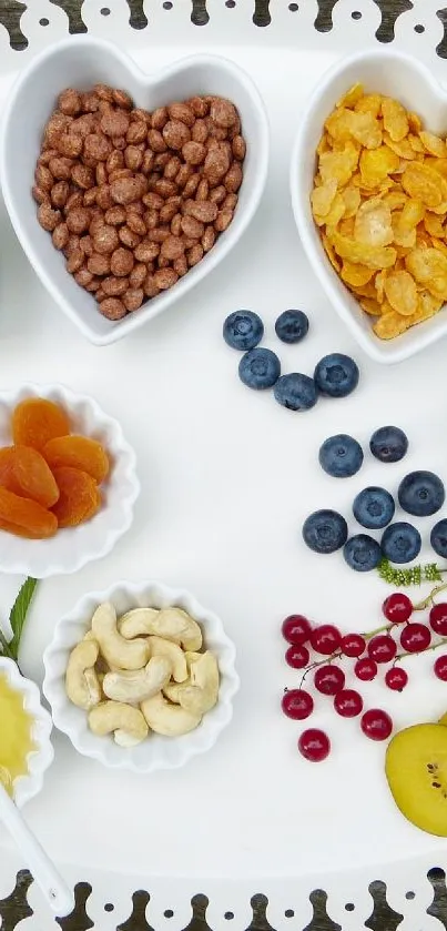 Tray of colorful snacks in heart-shaped bowls on a wooden table.