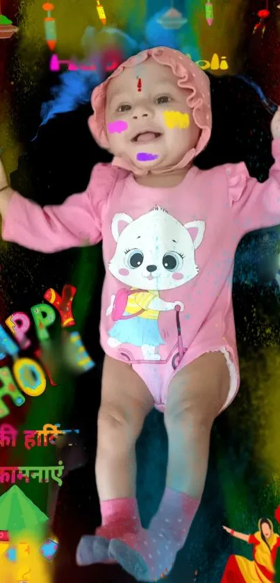 Vibrant Holi baby wallpaper with pink outfits and festive colors.