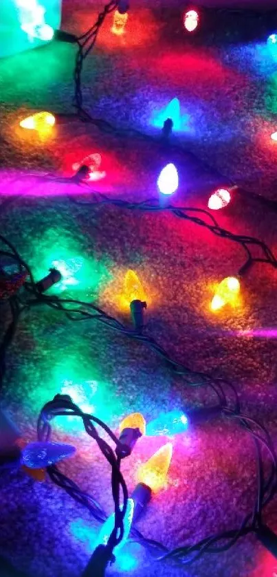 Mobile wallpaper featuring colorful holiday lights on a dark background.