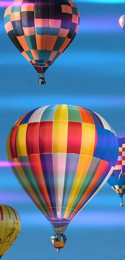 Colorful hot air balloons floating in a clear blue sky, creating a vibrant scene.