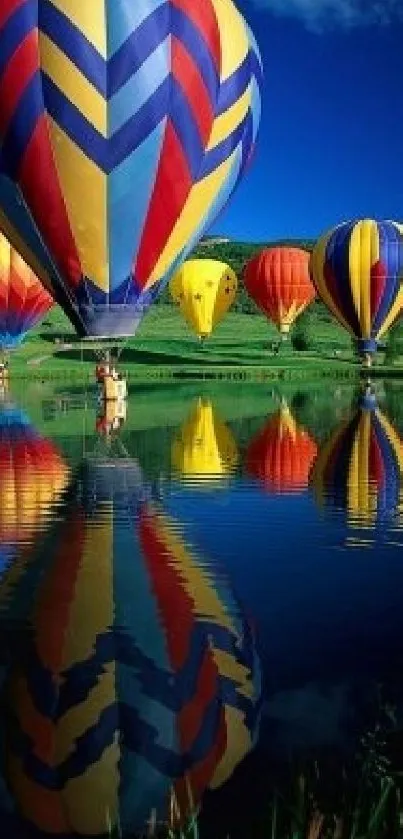 Colorful hot air balloons reflecting on a tranquil lake under a vibrant blue sky.